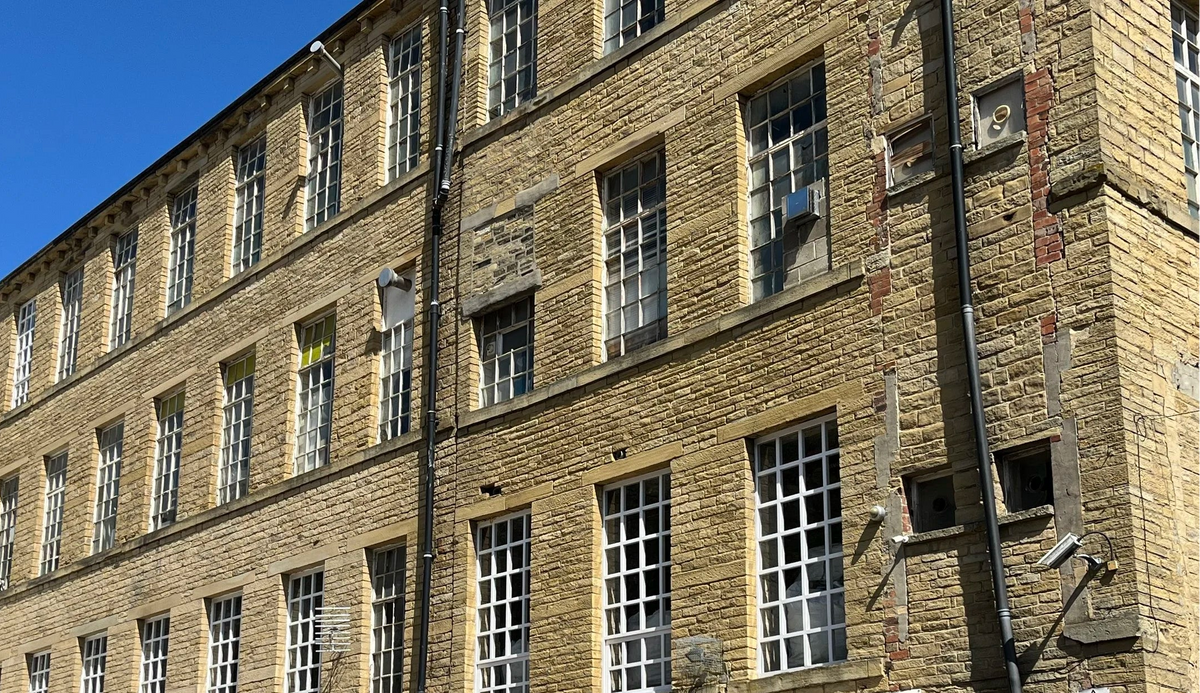 Brick building with a cafe sign on a clear day